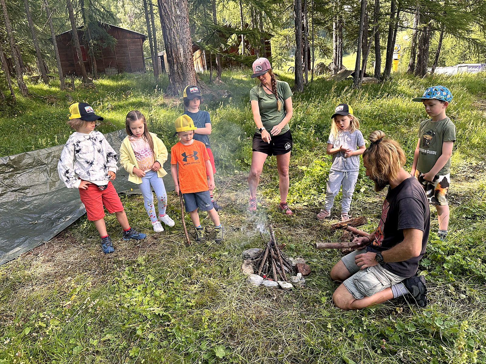 Little Explorers sitting around the campfire circle with their leaders